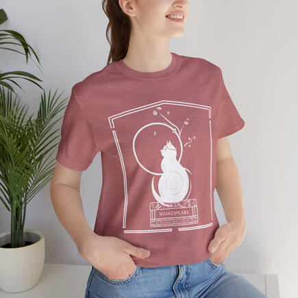A cat perches atop a stack of beloved classics under a full moon under the branch of a blooming tree on this soft, light shirt. Get cozy with the reading cat in 7 different colors and prepare for drama and comedy with Shakespeare, adventure with King Arthu